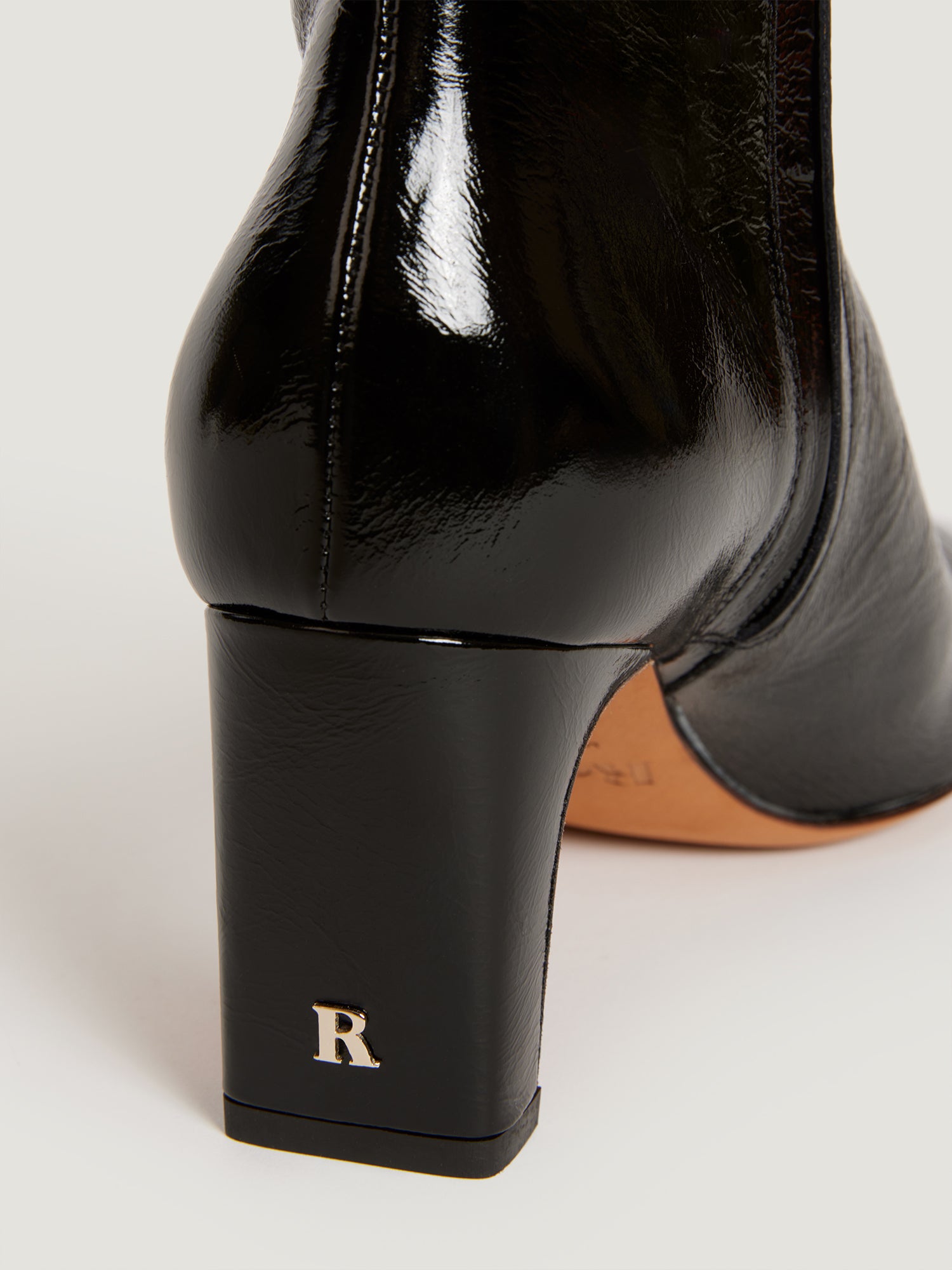 Heeled ankle boots in black patent leather | Rouje • Rouje Paris