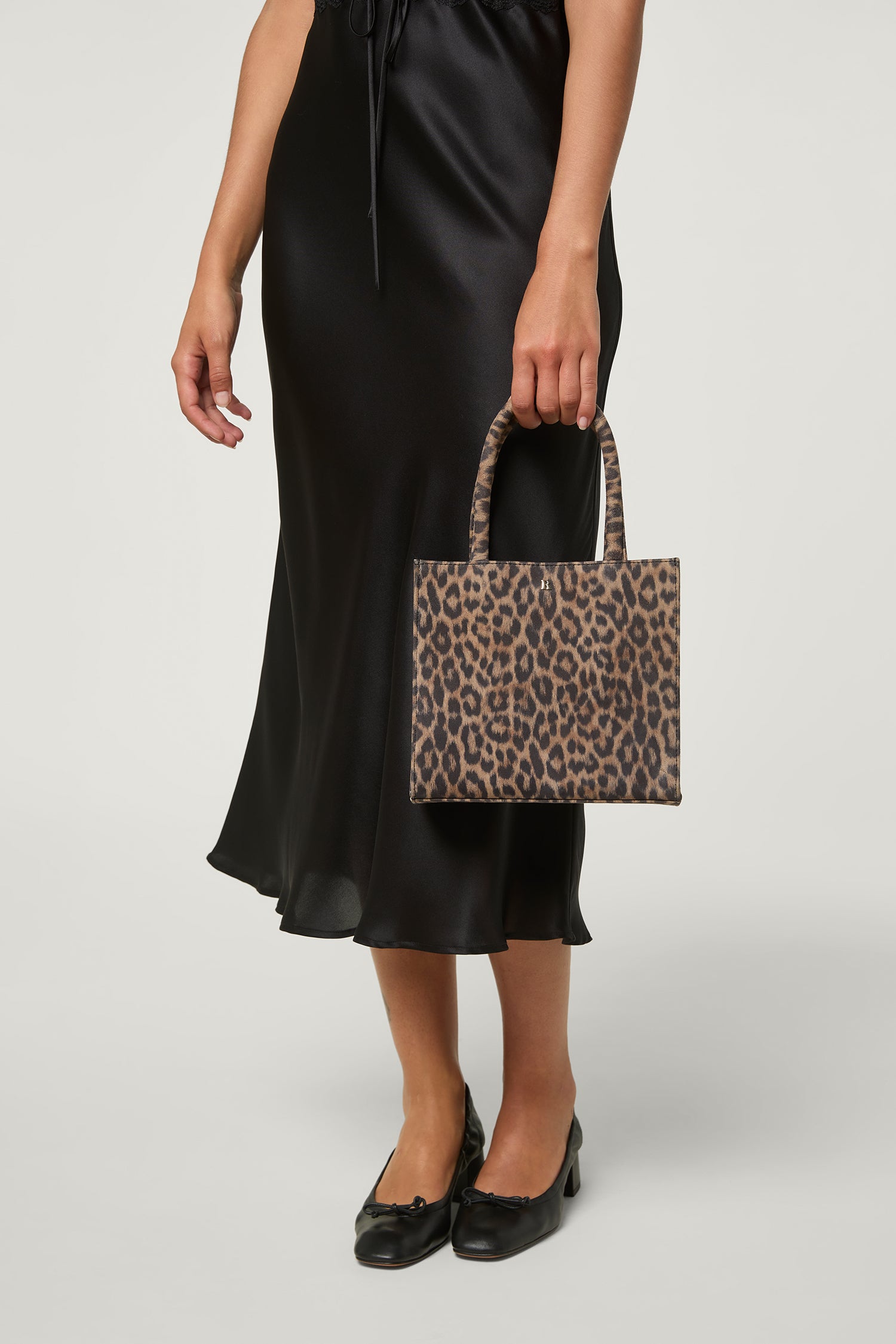 BALTIMORE (One of a kind animal print 2024 leather top handle pouch with suede ruffle trim)